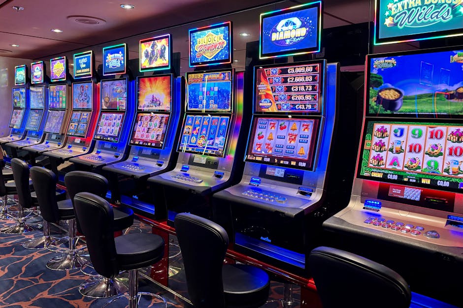Bright casino slot machines with colorful displays and no people present.