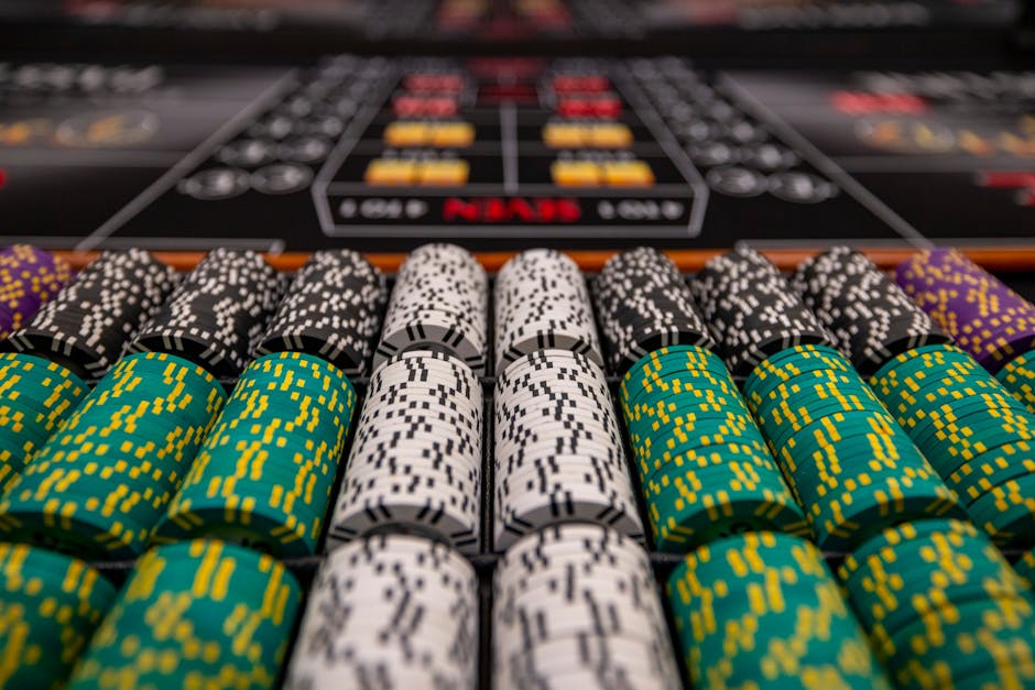 Close-up of colorful casino chips arranged on a gaming table, ready for play.